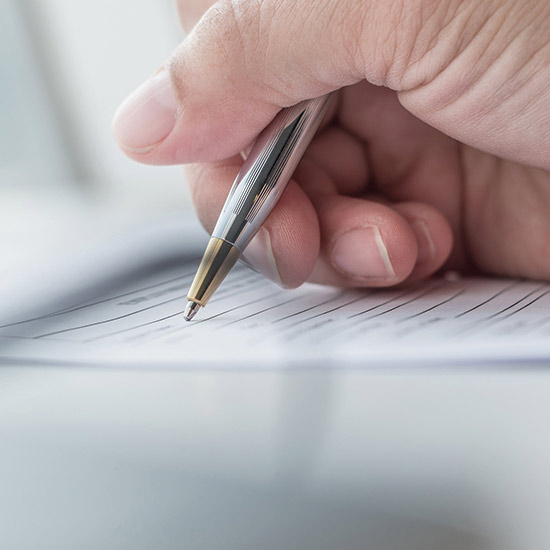 Registration Service Company Board of Directors; A hand holds a silver pen, poised to write on a lined paper. The focus is on the pen and fingers, conveying a sense of concentration and precision.
